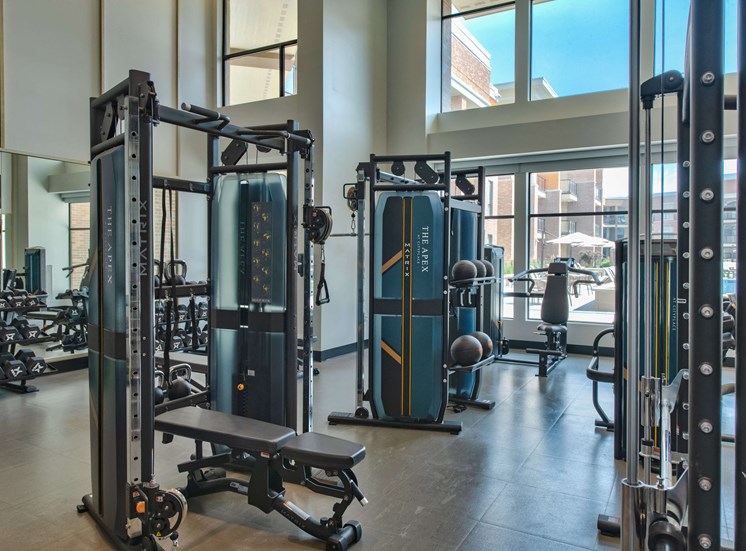 indoor gym with free weights, benches, and cable machines
